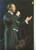 Singer Russell Watson signed 10 x 8 inch colour photo on stage. Good condition. All autographs