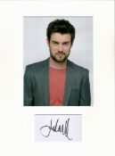 Jack Whitehall signature piece mounted below colour photo. Approx size 16x12.Good condition. All