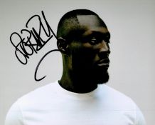 Stormzy signed 10x8 colour photo. Michael Ebenezer Kwadjo Omari Owuo Jr. (born 26 July 1993),