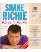Shane Richie signed Rags to Richie paperback book. Signed on inside title page. Dedicated. British