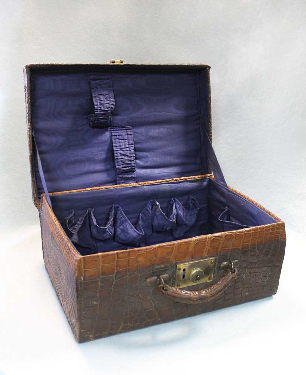 An early 20th century crocodile leather dressing case,