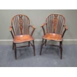 Circa 1860 two oak and elm hoop back Windsor elbow chairs with wheel back central splat on turned