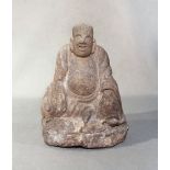 A Chinese cream stone seated figure of a smiling Putai, perhaps late Ming Dynasty, 21cm high
