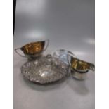 A silver dish together with a milk jug and sugar bowl and a pair of sugar nips, 22.2ozt along with a