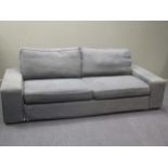 A contemporary grey upholstered three seater sofa, approx 230cm wide