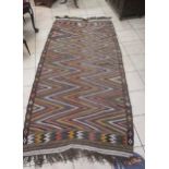 A tribal rug with coloured chevron pattern