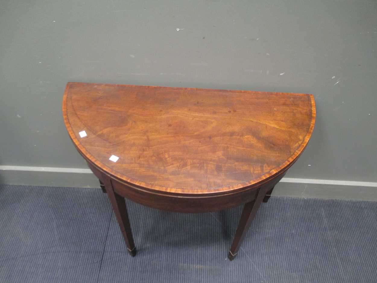 A George III mahogany demi-lune card table, with chevron banded top, on square tapering legs with - Bild 2 aus 5