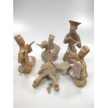 A group of five Chinese pottery musician and entertainer tomb figures, perhaps Han Dynasty,