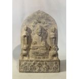 A Chinese grey stone Buddhist triad stele with aureole, in Wei Dynasty style, 25.5cm high