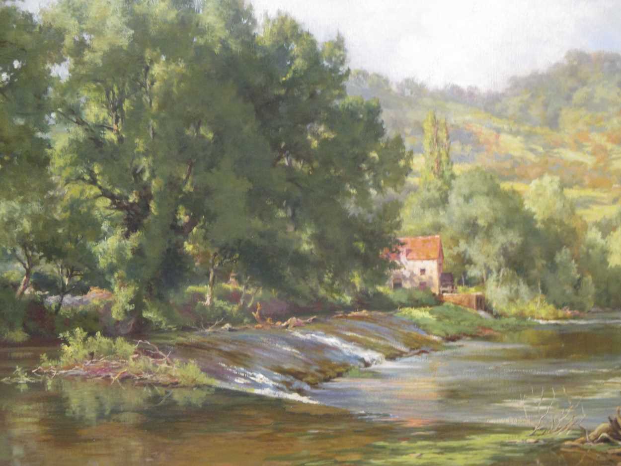 Manner of Alfred East, Cottage on the River Bank, oil on canvas, 48.5 x 74cm