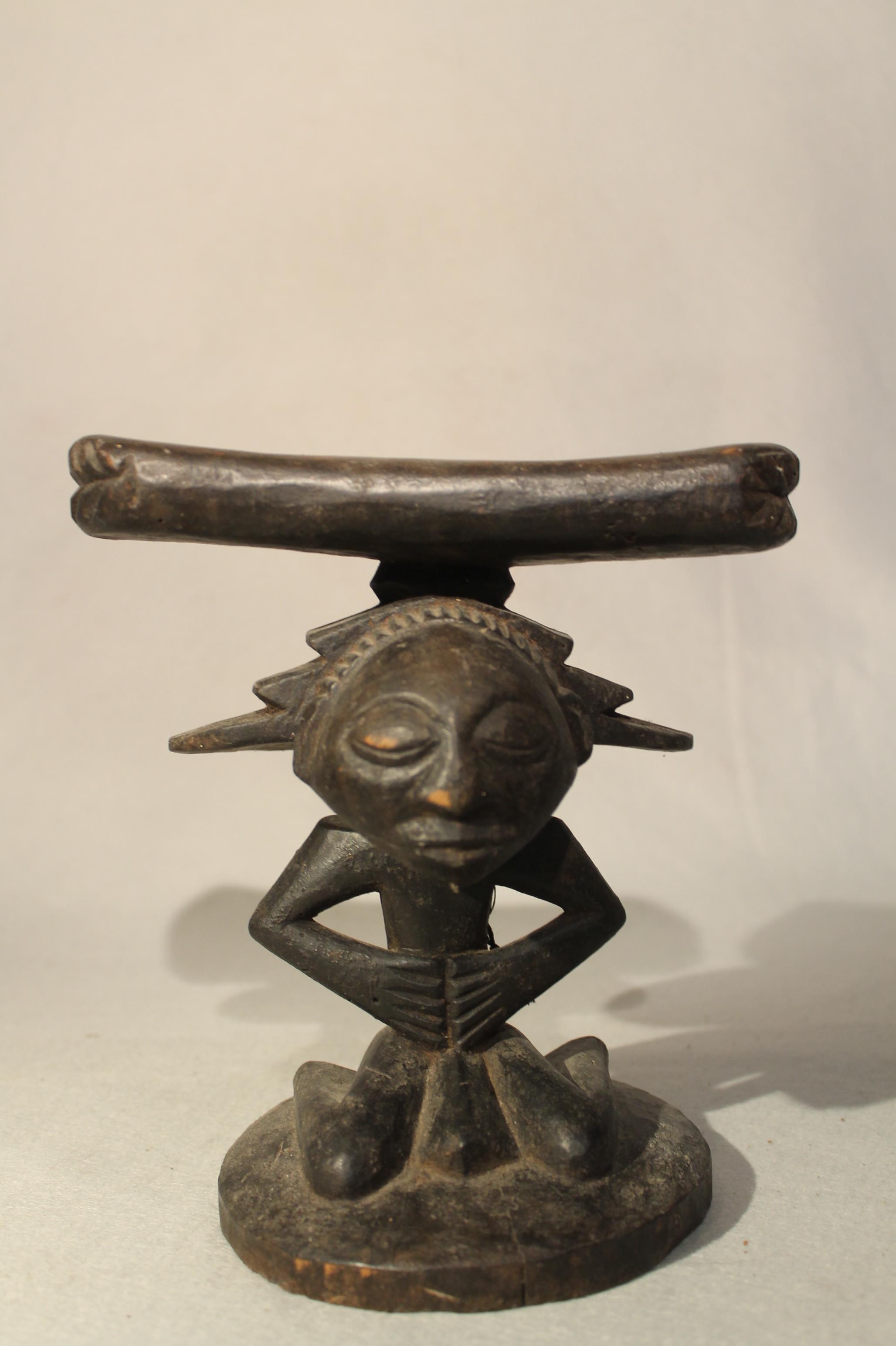A Baluba wood headrest, with stylized kneeling figure with stepped fan coiffure, 21cm high; an Ibo - Image 4 of 5