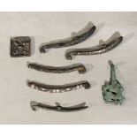 Six Chinese bronze and inlaid belt hooks in Han/Warring States style, and a square bronze "grape &