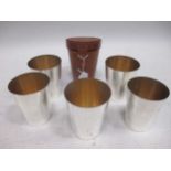 A set of 6 silver plated stacking stirrup cups by Asprey, leather cased