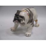 A model bulldog together with three pairs of vintage ice skates