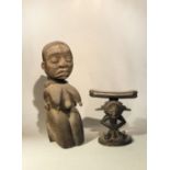 A Baluba wood headrest, with stylized kneeling figure with stepped fan coiffure, 21cm high; an Ibo