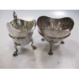 An early 20th century silver jug and sugar bowl on three hoof feet, 8.9ozt