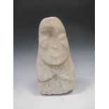 A Chinese carved stone head of a bearded man, of stylised form, perhaps Neolithic, 29cm high