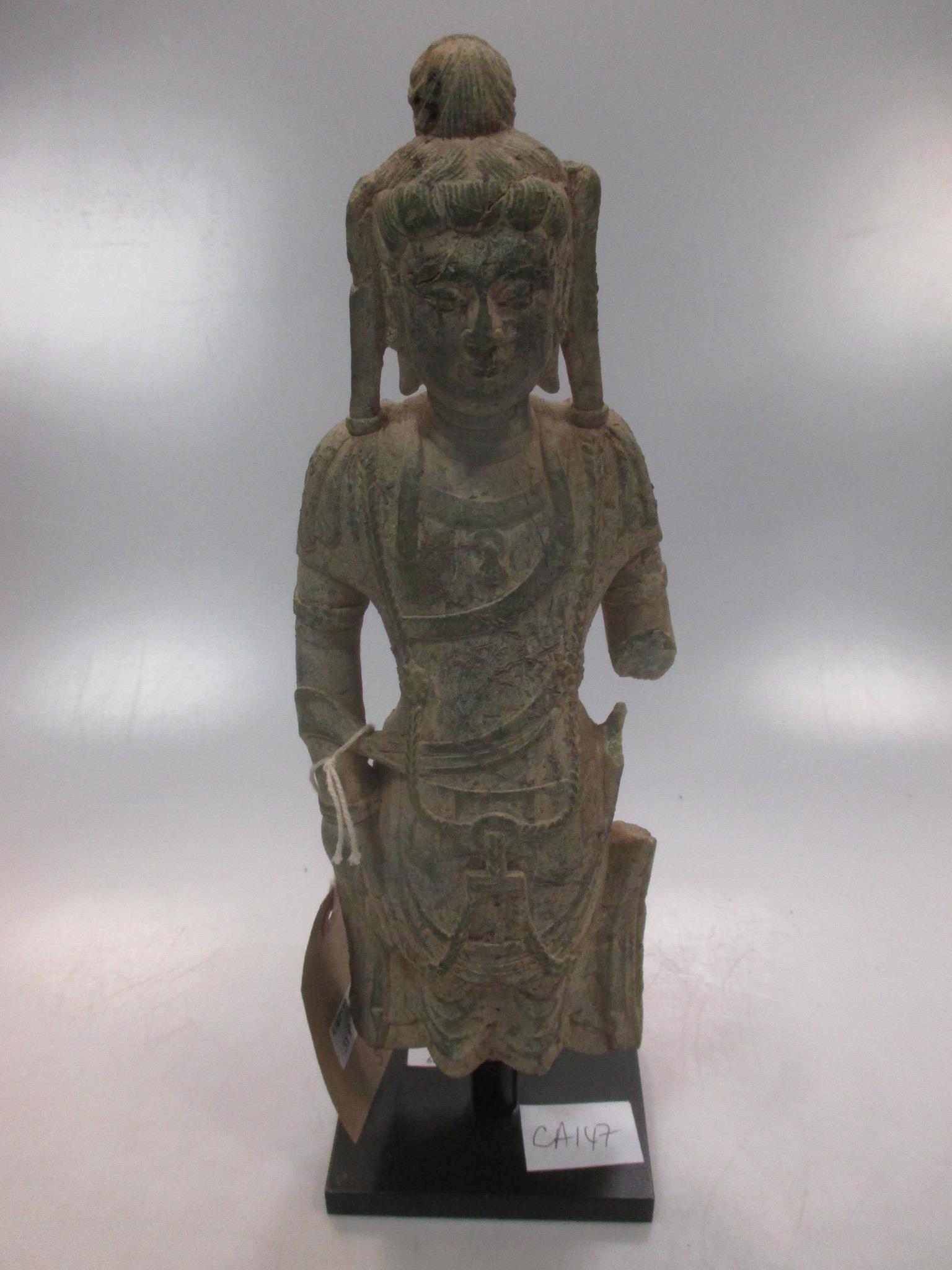 A Chinese carved limestone fragmentary carved figure of a Bodhisattva, in Northern Wei style, 29cm