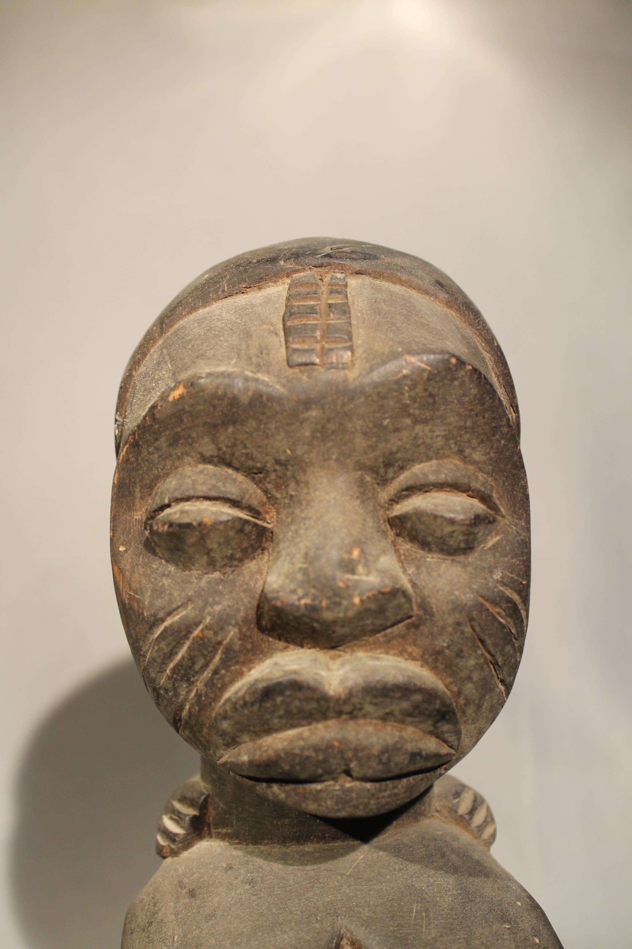 A Baluba wood headrest, with stylized kneeling figure with stepped fan coiffure, 21cm high; an Ibo - Image 3 of 5