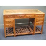 A Chinese twin pedestal desk, 20th century, with a row of frieze drawers, and three drawers to