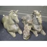 A pair of recumbent reconstituted stone horse and another small stone figure. (3).