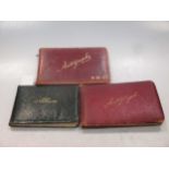 Three small autograph albums: one mainly including cut signatures of G A Henty, Rider Haggard,