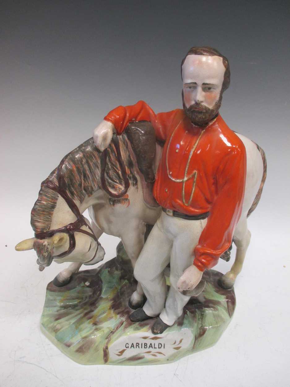 A large Staffordshire pottery group of Garibaldi standing aside his horse, 37cm high (restored)