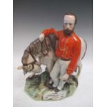 A large Staffordshire pottery group of Garibaldi standing aside his horse, 37cm high (restored)