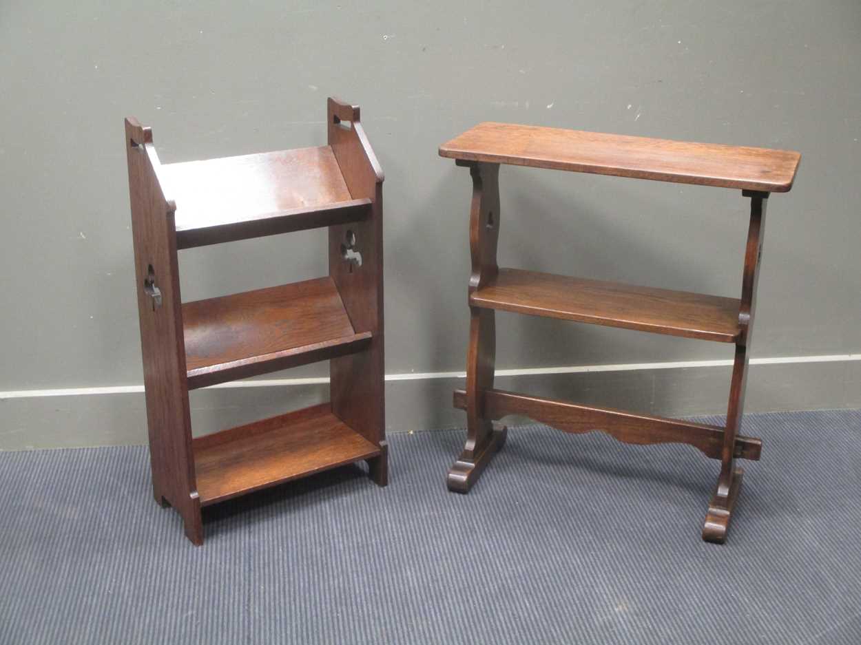 Two Arts & Crafts oak bookshelves each with clubs fret work decoration, measuring 84cm high by