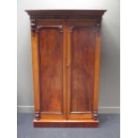 A mahogany two door wardrobe with moulded decoration 207 x 115 x 63cm