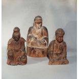 Three Chinese carved wood seated figures, two of a Buddha, the other of Guanyin with child,