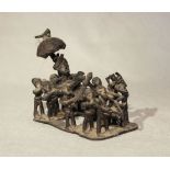 A West African bronze small group, of a chief being carried on a canopied palanquin by eleven men,