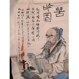 A Chinese painting, 20th century, of a scholar at his desk with books by candlelight, inscription