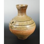 A Chinese olive glazed pottery vase, hu, mask lugs, probably Han Dynasty, 46.5cm high