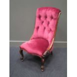 A Victorian mahogany nursing chair, with pink velvet button back upholstery and cabriole front legs