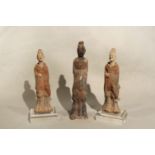Three Chinese pottery figures of standing attendants/entertainers, perhaps Sui Dynasty, tallest 24cm