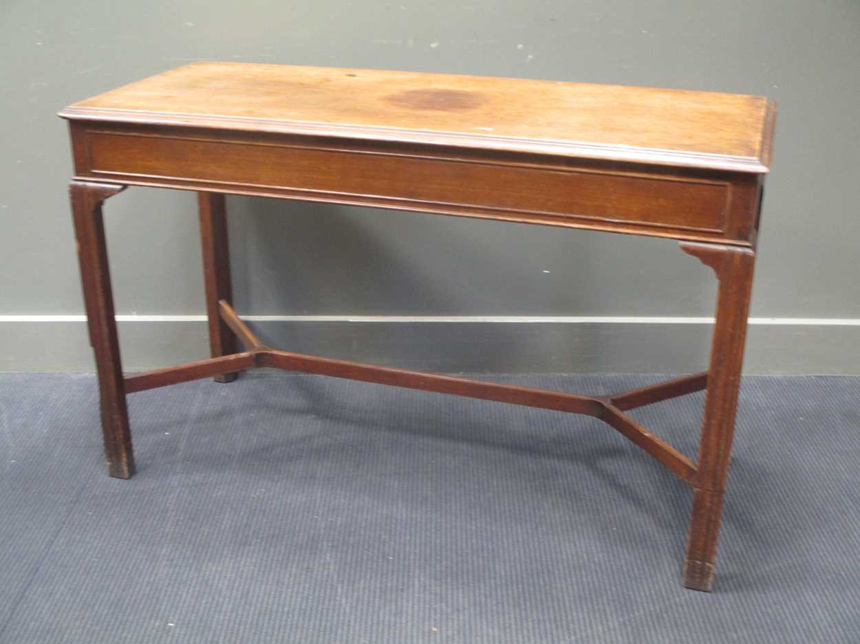 A George III style mahogany slender rectangular table, on moulded legs with shaped stretcher 77 x
