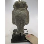 A grey stone head of a Bodhisattva, 11cm high (14cm high to include the stand)