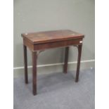 A George III mahogany fold over top tea or card table, now with lined interior on square chamfered