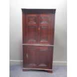 A George III north country oak full height corner cupboard with mahogany mouldings and two keys, 204