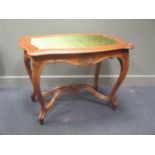 A carved centre table on cabriole legs with scrolling x stretcher 75 x 104 x 74cm