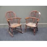 A Victorian child's yew and elm rocking armchair, circa 1850 and another similar armchair, each with