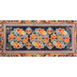 A Chinese woollen rug, circa 1930, 130 x 74.5cm; a woollen three medallion rug, possibly Tibetan,