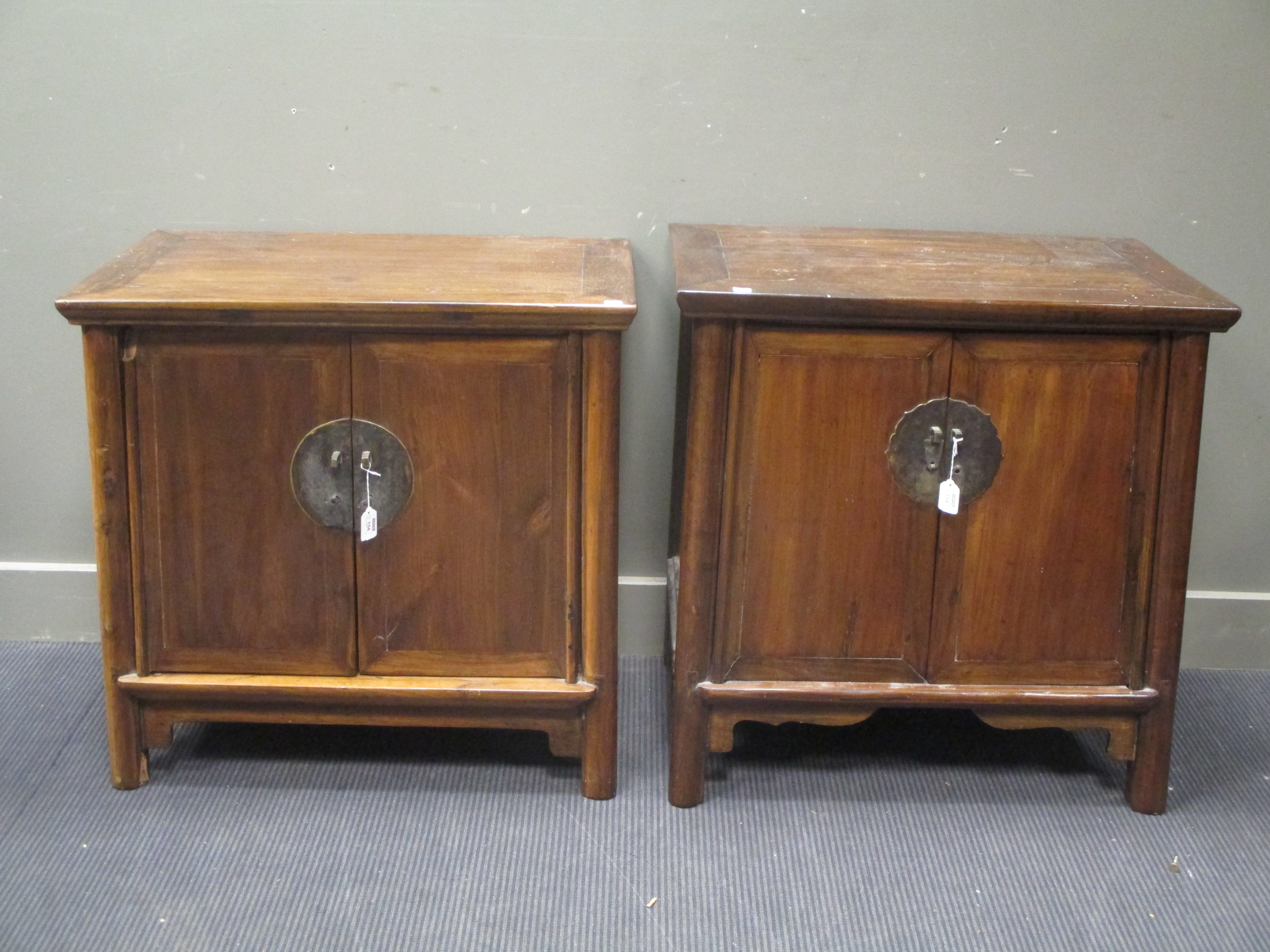 Two similar Chinese hardwood cupboards, 20th century, in Ming Style, each with cupboard fronts, on