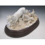 A Continental porcelain white glazed stag hunting group, some damage, mounted on a wooden base, 44cm