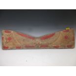 A North American Indian carved and painted pine rest panel, carved in low relief with a stylized