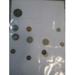 A folder of coins, including 1887 half sovereign, some worn silver coinage and commemorative Royal