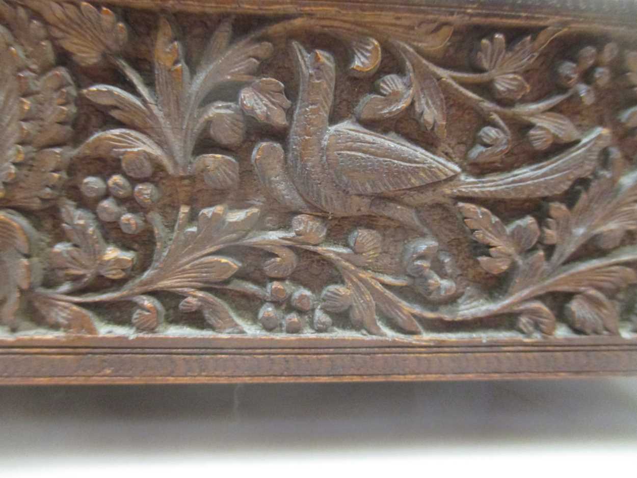 An Indian/Asian carved wood box, probably c.1900, with three figures to the lid, on brass feet, 23 x - Image 6 of 6