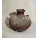 A Chinese brown glazed pottery vase, compressed with pierced tab shoulder handles, probably Liao