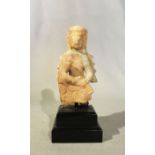 A Chinese white marble seated Guanyin, in 6th/7th Century style, with rudimentary repair, 14.5cm